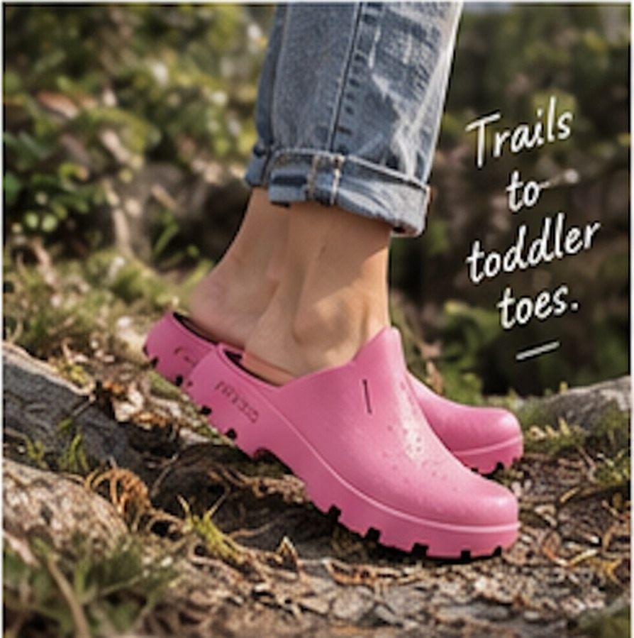Child in pink PUDDS on a muddy trail